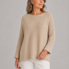 organic cotton jumper with long sleeves and ribbing in camel colour presented on middle age woman
