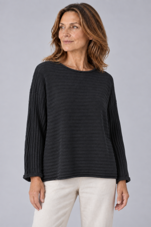Lark-organic-cotton-jumper-black organic cotton jumper with long sleeves and ribbing in black colour presented on middle age woman