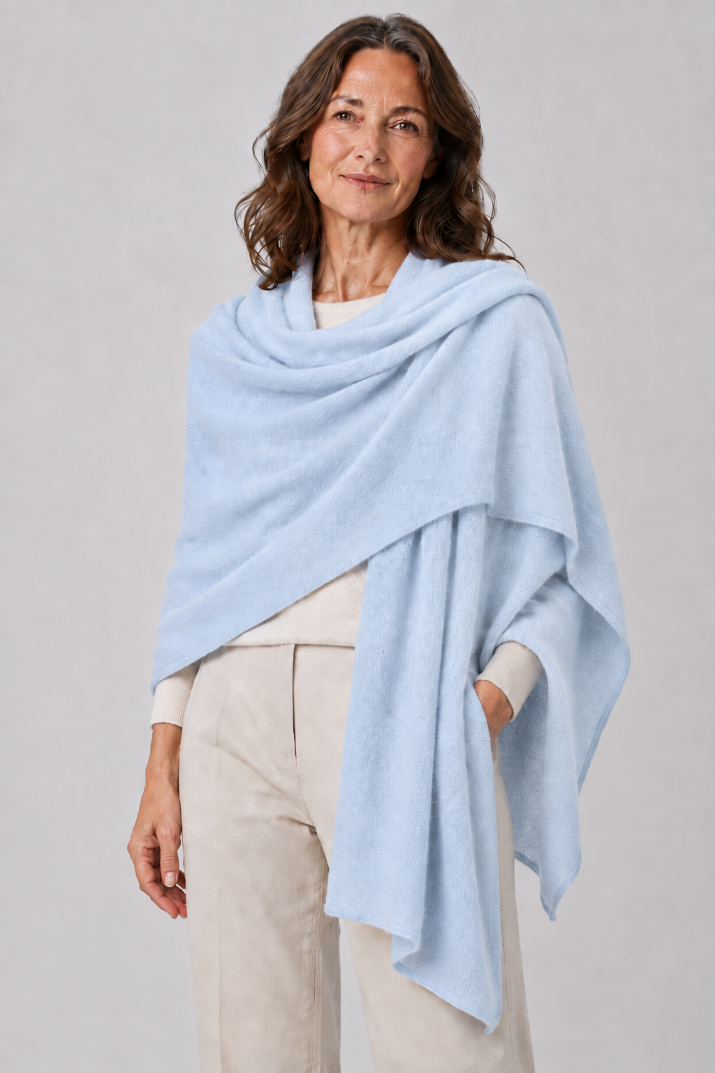 cashmere travel wrap in cloud blue colour wrap around female model