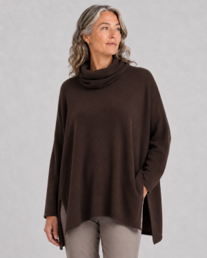oversized jumper with turtle neck in bitter brown colour displayed by model