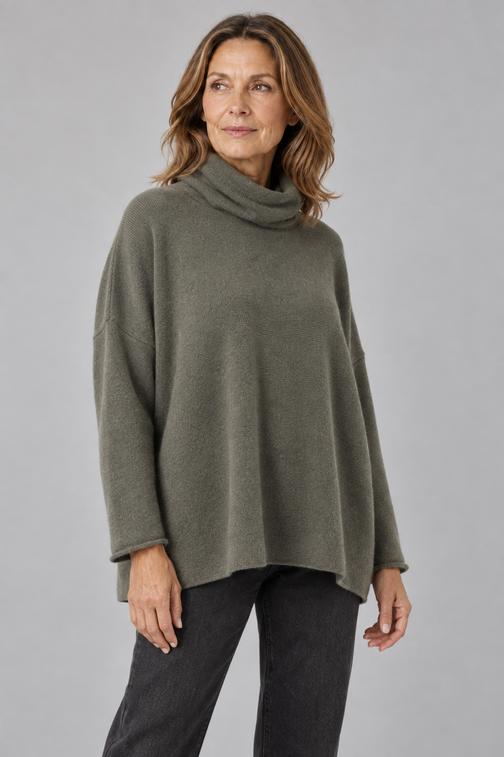 Sweater in Fir Green worn by a model, showing the soft polo collar, relaxed square shape and rolled sleeve edges.