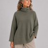pesto-sweater-fir-green-model-front-view - Ochre Knitwear Pesto Sweater in Fir Green worn by a model, showing the soft polo collar, relaxed square shape and rolled sleeve edges.