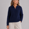 Model wearing the navy Cable Jumper with collared open neckline, all-over cable knit texture, ribbed hem and ribbed cuffs.