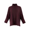 an oversized jumper featuring long sleeves, a high ribbed neckline, and a center front opening, presented in a burgundy colour, viewed from the front
