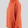 oversized jumper with turtle neck in flame colour side view