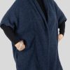 a mohair cardigan featuring short sleeves, two side pockets, and a cocoon shape, presented in a side view