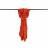 Orange cashmere shawl with fringed edges, draped