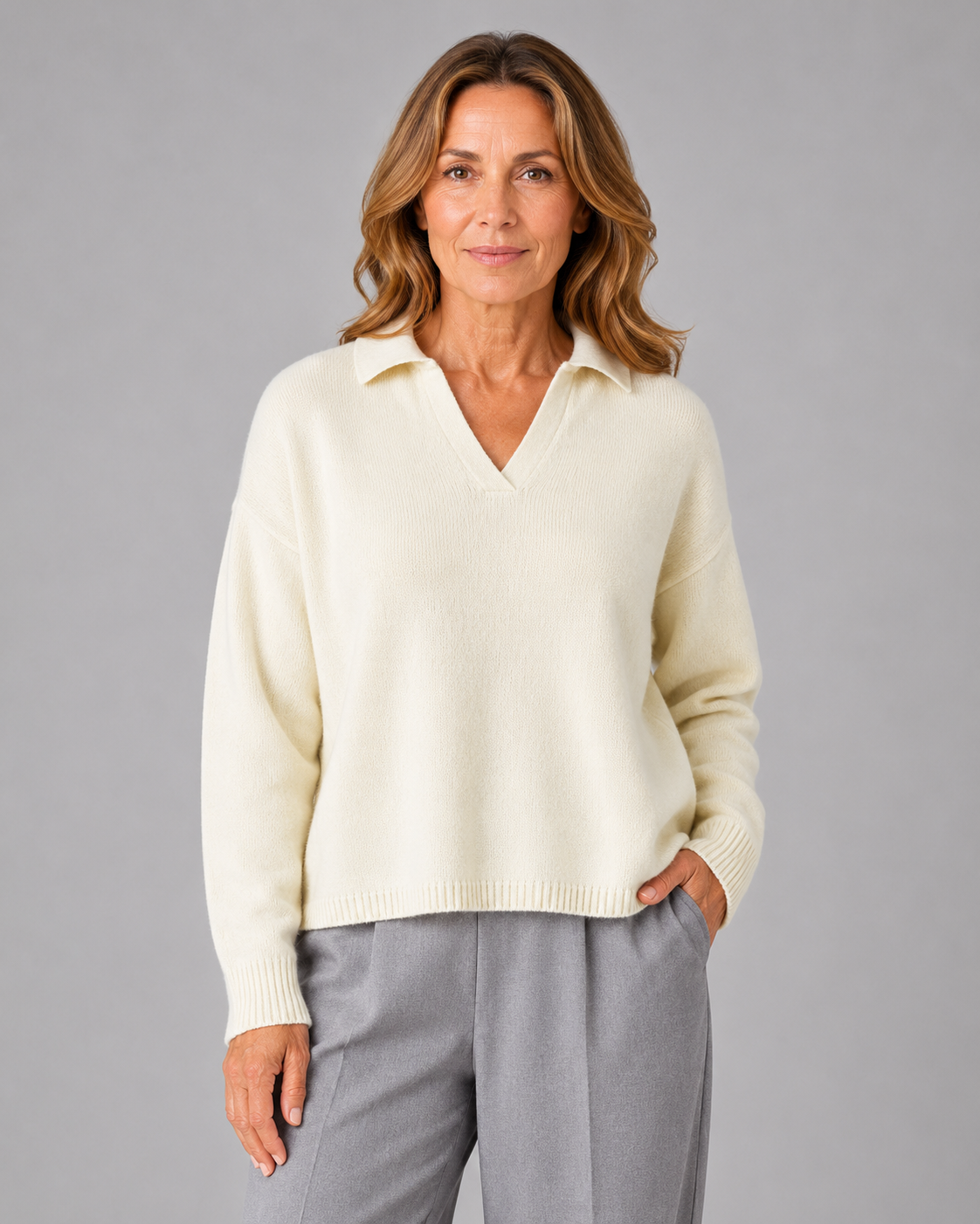 Rumble-collared-jumper-model - Ochre Knitwear collared cashmere blend jumper with open V neckline and dropped shoulders front view in buttermilk colour, presented by female mature model
