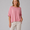 Jin-high-low-knit-jumper-monet-pink-model - Ochre Knitwear high low knit jumper in cashmere blend with boat neckline and relaxed silhouette in monet pink colour, front view