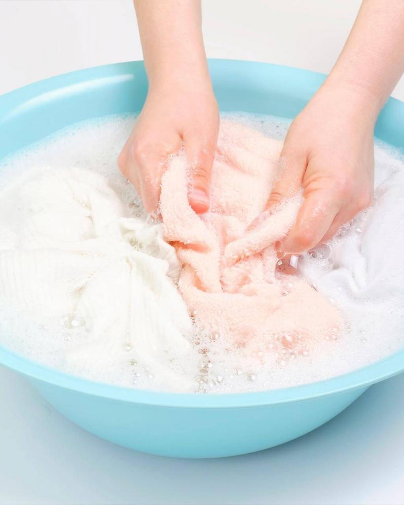 can you wash cashmere instead of dry cleaning, woman hand washing cashmere