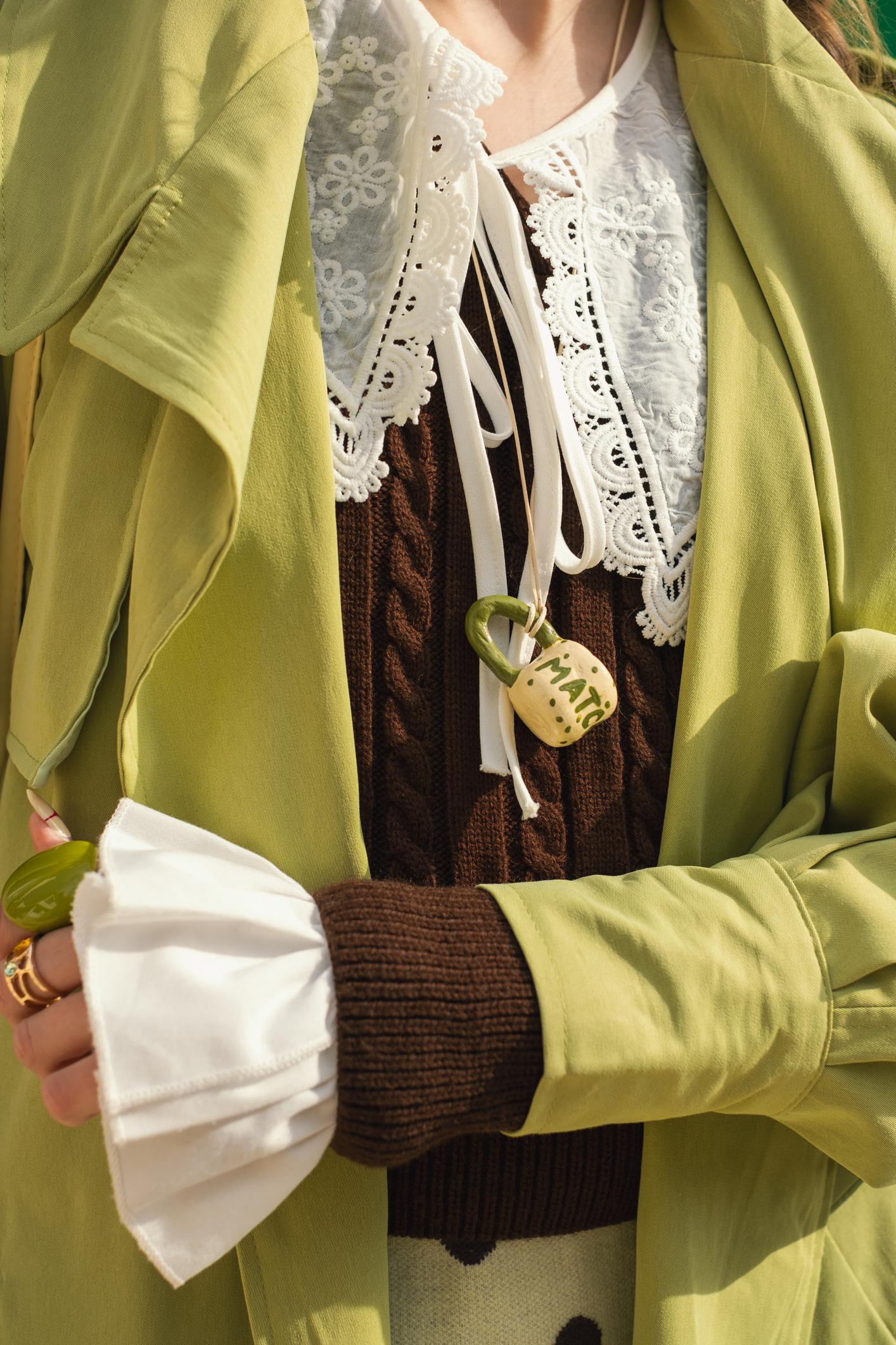 what to wear under cashmere sweater, woman wearing shirt under cashmere jumper