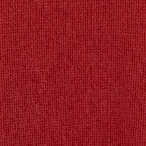 Close-up of red knit fabric showing interlocking stitches and texture (fabric macro).