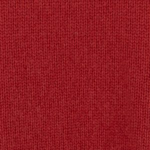 rust - Ochre Knitwear Close-up of red knit fabric texture showing interlocking stitches