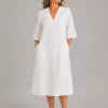 Jane-linen-tunic-dress-ivory-front-model copy - Ochre Knitwear linen tunic dress in ivory organic linen with V-neckline, three-quarter sleeves and relaxed longline shape, front view