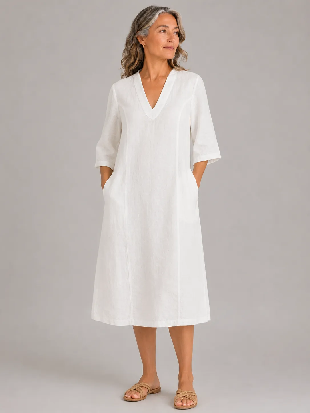 Jane-linen-tunic-dress-ivory-front-model copy - Ochre Knitwear linen tunic dress in ivory organic linen with V-neckline, three-quarter sleeves and relaxed longline shape, front view