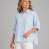 Linda-linen-shirt-pale blue-front-view - Ochre Knitwear Light blue button-down shirt on a torso mannequin with sleeves casually rolled up against a light gray background.