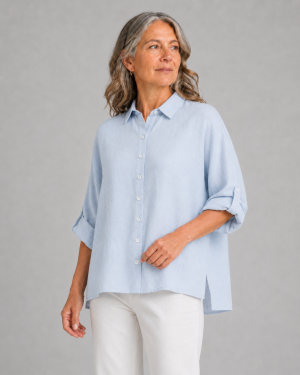 Light blue button-down shirt on a torso mannequin with sleeves casually rolled up against a light gray background.