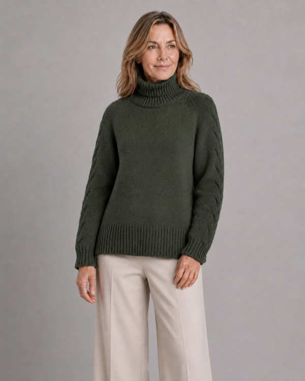 cable sleeve roll neck jumper with high ribbed collar, raised sleeve detail, deep ribbed hem and relaxed winter knit shape, presented by female model