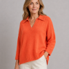froyo-collared-v-neck-jumper-front-flame-model - Ochre Knitwear collared V-Neck jumper with wide ribbed collar, dropped shoulders, open placket and curved ribbed hem, in flame colour