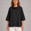 linen cowl neck top in black organic linen with folded neckline and wide short sleeves, presented by model, front view