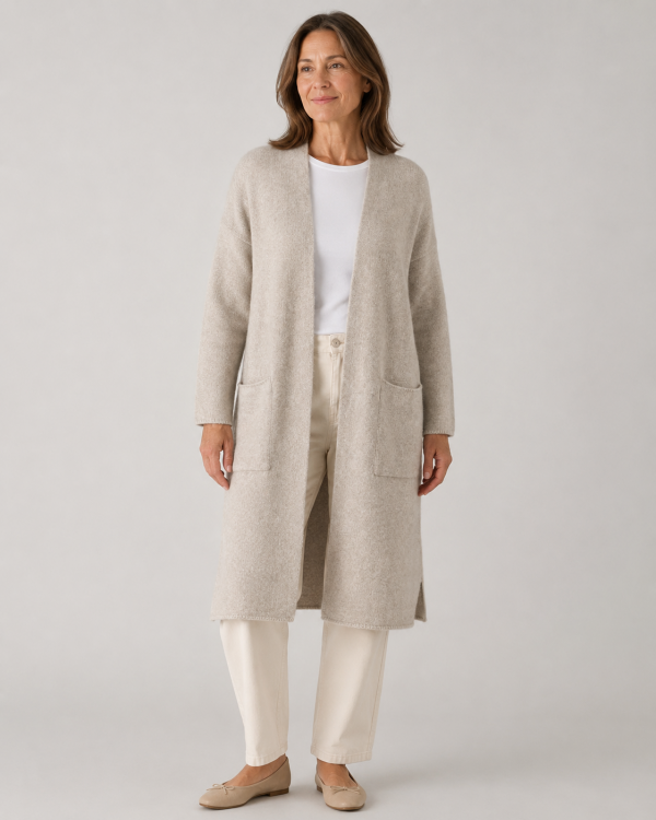 long yak wool cardigan with open front, dropped shoulders and two patch pockets, front view in stone colour, presented by middle age woman model