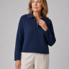 Mature model wearing the Elida zip collar cardigan, a cropped collared knit with ribbed sleeves and zip front