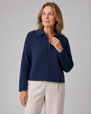 Elida-zip-collar-cardigan-navy-model Mature model wearing the Elida zip collar cardigan, a cropped collared knit with ribbed sleeves and zip front