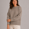 chunky yak crew neck jumper front view with dropped shoulders, full sleeves and deep ribbed hem presented by female mature woman