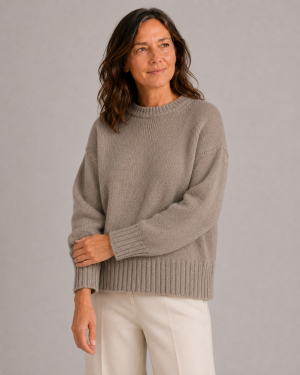 chunky yak crew neck jumper front view with dropped shoulders, full sleeves and deep ribbed hem presented by female mature woman