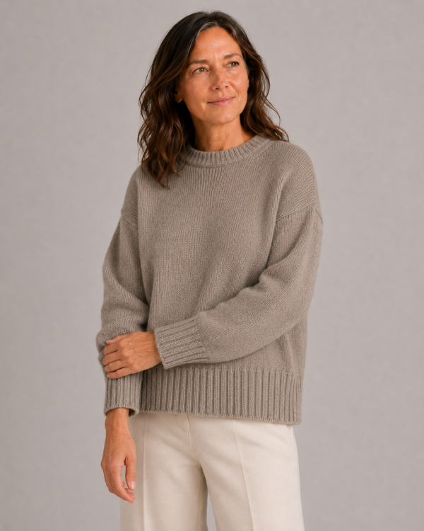 chunky yak crew neck jumper front view with dropped shoulders, full sleeves and deep ribbed hem presented by female mature woman