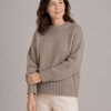 chunky yak crew neck jumper front view with dropped shoulders, full sleeves and deep ribbed hem presented by female mature woman
